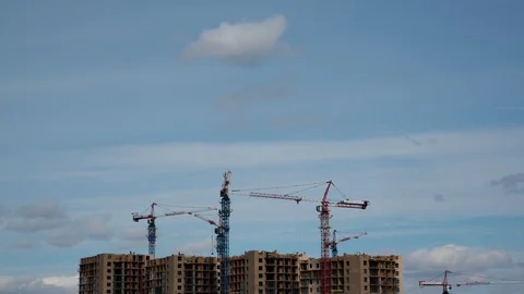 Lots of tall construction cranes. Sky and clouds in the background.  Video stock 108648218