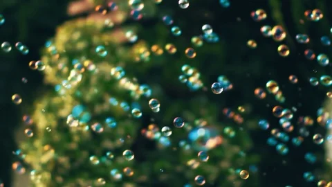 Lots of tiny soap bubbles floating in the air on a sunny summer day on a ba.. Stock-Footage 70558987
