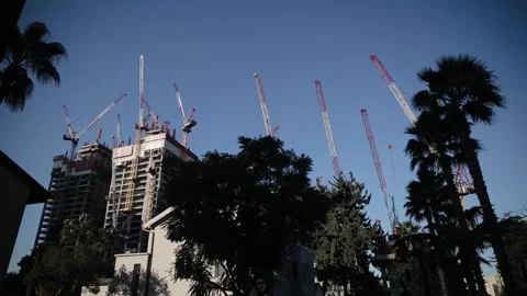 Lots of tower cranes, construction of residential buildings. Low angle view of Stockbeeldmateriaal 273916034