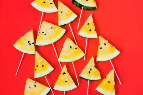 A lots of triangular pieces of ice cream on a stick of ripe yellow watermelon 写真素材