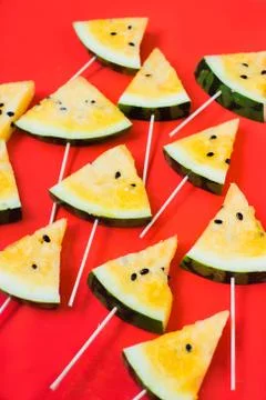 A lots of triangular pieces of ice cream on a stick of ripe yellow watermelon 写真素材