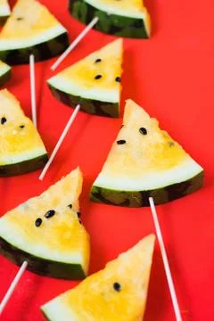 A lots of triangular pieces of ice cream on a stick of ripe yellow watermelon 写真素材
