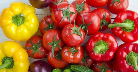 Lots of vegetables on a red background. Stock Photos