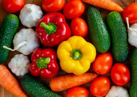 Lots of vegetables on the table. Harvesting. Several tomatoes, cucumber, carr Stock Photos