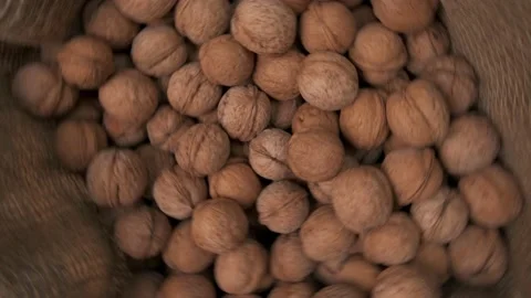 Lots of walnuts in a canvas bag, rotating on their axis Stock Footage 150588939