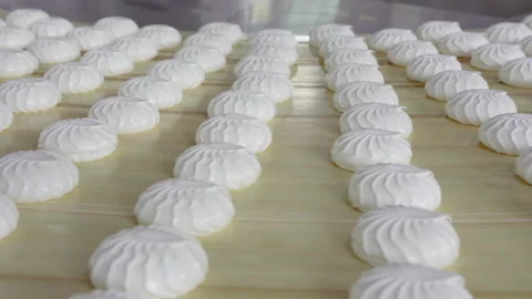 Lots of white, fresh marshmallow on a light wooden table, side view Stock Footage 113182774