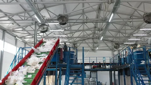 Lots of workers separating the waste material at the plastic recycling plant Stock-Footage 275588339