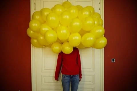 Lots of yellow baloons instead of head, undefined model Stock Photos