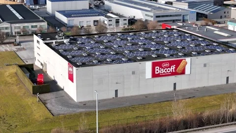 Lotus biscoff warehouse flat black roof solar panels ventilation units large red Stock Footage 329090807