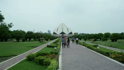 Lotus Temple in the distant background and tourists in garden foreground. 動画素材 94893162