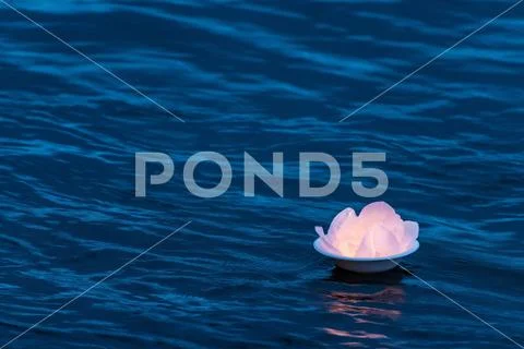Lotus water lantern lamp on top of the river surface floating down the stream Stock Photos