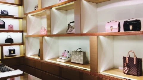 Louis Vuitton brand store interior, luxury fashion shopping experience Stock Footage