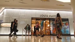 BANGKOK - MARCH 17, 2016 : Unidentified People Stand In Queue To Get To A  Louis Vuitton Store In The Siam Paragon Shopping Mall. For Years 2006–2012  LV Was Named The Worlds