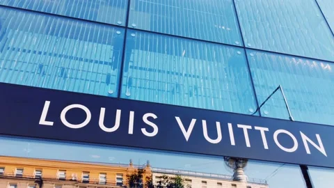 Louis Vuitton logo displayed at boutique storefront, fashion and leather goods Stock Footage