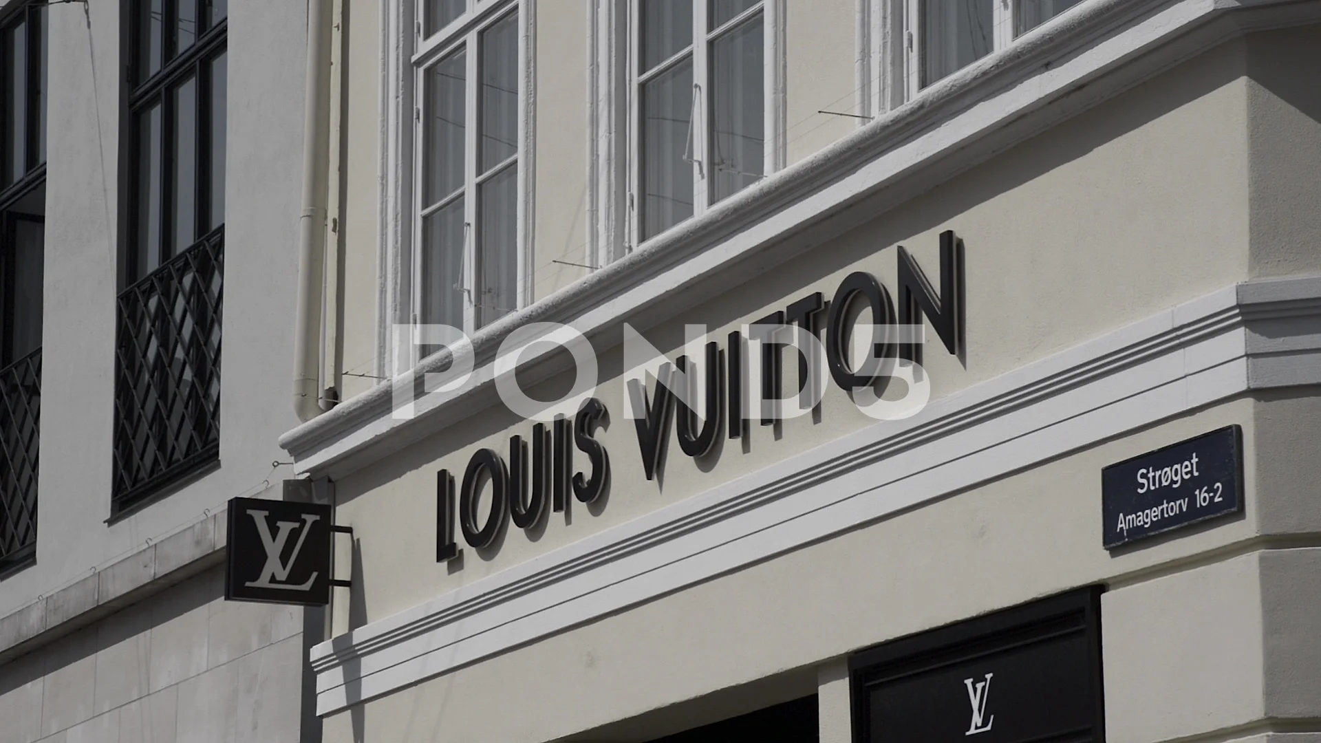 Louis Vuitton sign on front of the store, Stock Video