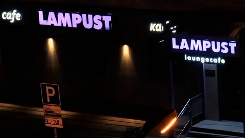 Lounge cafe with the name LAMPUST at night Stock Footage 78418953