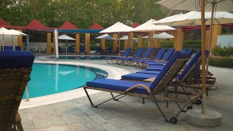 Lounge chairs by the pool Stock Footage 107891664
