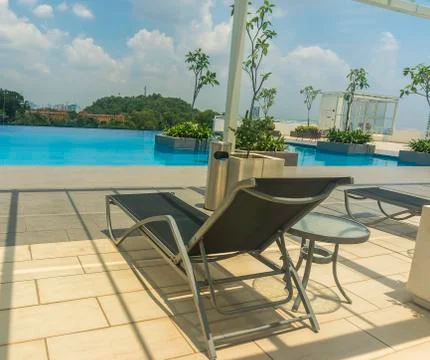 Lounge chairs by the pool Stock Photos