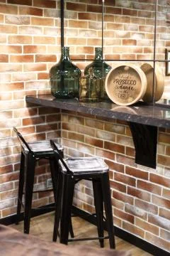 Lounge, stylized as a bar. Corner worktop against the wall. Stock Photos