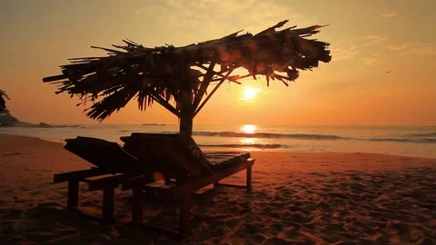 Loungers on the beach at sunset Stock Footage 73566317