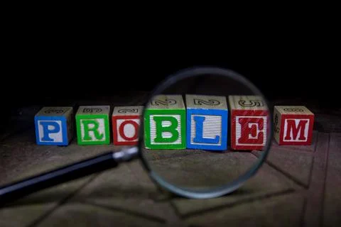 Loupe analysing the word "problem" in front of a white background Stock Photos