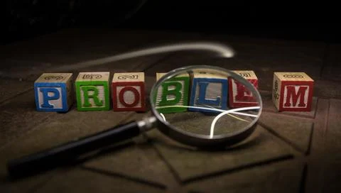 Loupe analysing the word "problem" in front of a white background Stock Photos