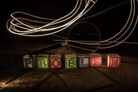 Loupe analysing the word "problem" in front of a white background Stock Photos