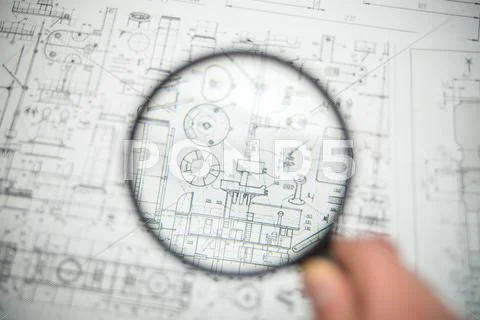 The loupe (magnifier) look through by blueprints engineering project background Stock Photos