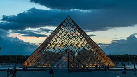 The Louvre museum pyramid after sunset day to night timelapse in Paris, France Stock Footage