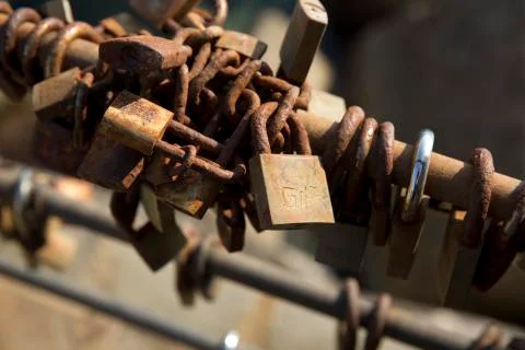 Love and Eternity padlocks fixed on to the end of the railings at Cefalu Harb Stock Photos