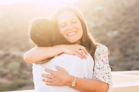 Love and friendship concept twith couple of women young friends hugging and s Stock Photos