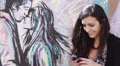 love and happy woman sends a text message to her boyfriend - graffiti HD Footage
