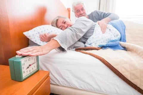 Love between senior couple in th ebed Stock Photos