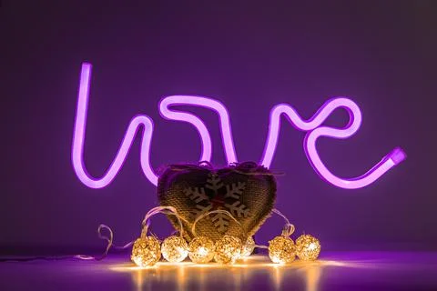Love concept creative frame with glowing title and heart with lights Stock Photos