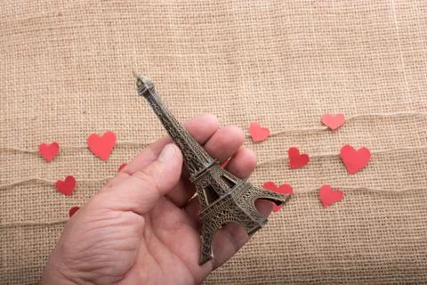 Love concept with Eiffel tower in hand and heart Stock Photos