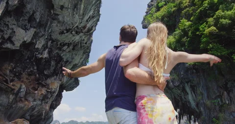 In love couple on authentic, romantic long tail boat tour, raising arms at the b Stock Footage 201093914