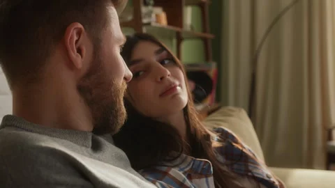 Love couple sit on sofa together relaxing Stock Footage 266806953