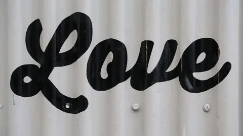 Love Hand Painted on Grey Sheet Metal Building (Gritty Urban Street Art)  Stock Footage 219374267