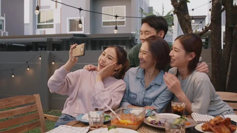 Love hug cuddle mom taking selfie on Mother day family dinner party. Stock Footage 241462673