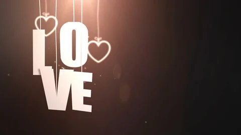 LOVE letters hanging on string falling from the ceiling with black backgound Stock Footage 105964333