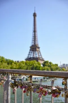 Love locks on bridge with Eiffel Tower view Stock Photos