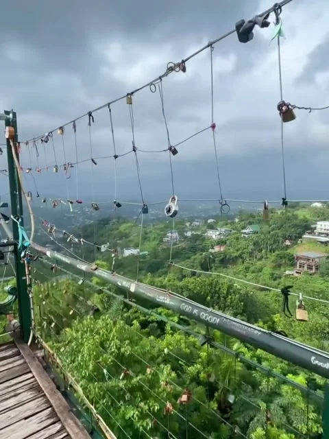 Love Locks on a Bridge Overlooking a Green Valley and Cloudy Sky Stock Footage 342264935