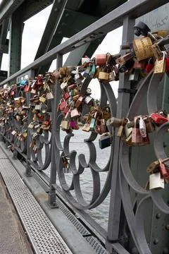 Love Locks at Eiserner Steg (Iron Footbridge) at River Main and skyscrapers.. Stock Photos