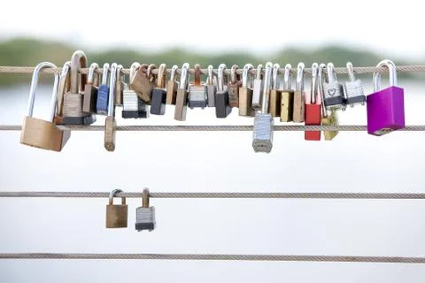 Love Locks Hanging from a Cable Railing Stock Photos