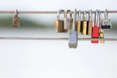 Love Locks Hanging from a Cable Railing Stock Photos
