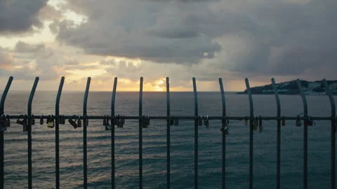 Love Locks Silhouetted Against Ocean Sunset Horizon Vídeo Stock 331115566