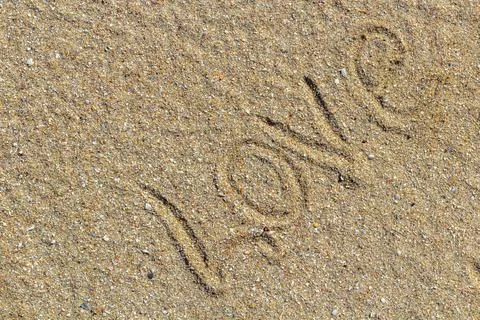 Love message written in sand, background for design Stock Photos