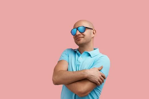 Love myself. Happy bald homosexual man with bristle smiles, embraces himself  Stock Photos