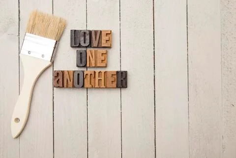 "Love One Another" Spelled in Type Set - Sometimes love is shown by serving e Stock Photos