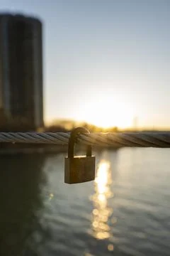 Love Padlock on Bridge at Sunset with Reflection in Water Photos